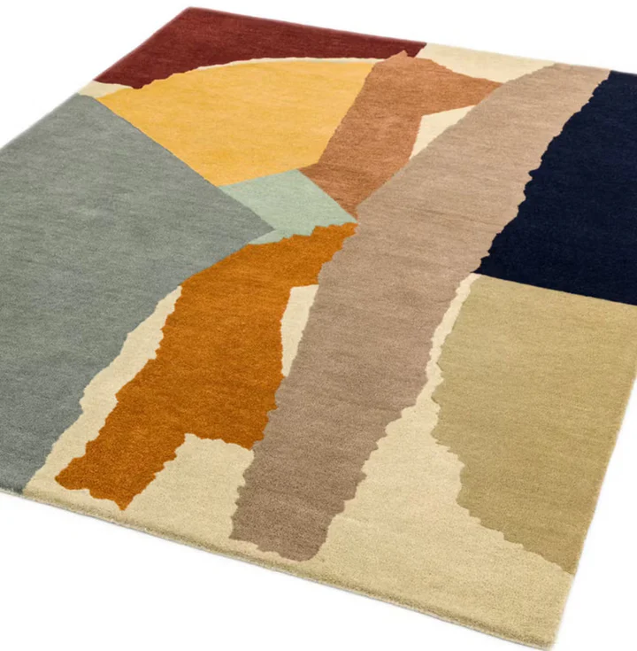 Layered Canvas hand tufted wool rug shown from angled perspective highlighting layered abstract pattern and color blocks.