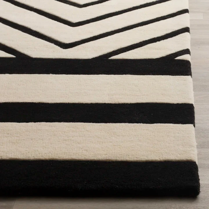 Close up texture detail of ModuLinea Abstract Geometric hand tufted wool rug showing wool pile contrast striped pattern and craftsmanship.