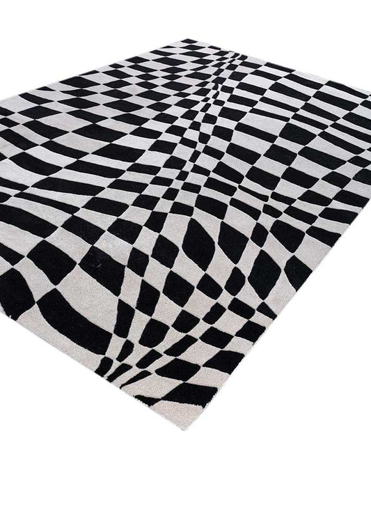 Side angle view of Abstract Optical hand tufted wool rug showing thickness and edges.