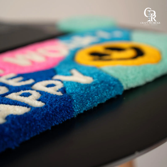 Close view of Be Happy Desk Rug highlighting soft handmade texture and detailed don’t worry be happy lettering