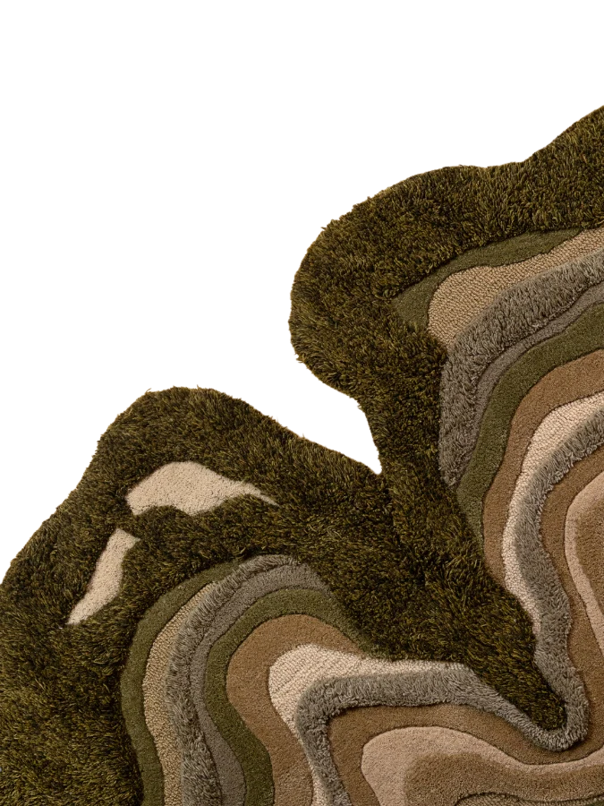 Corner view of Greencrest Terrain hand-tufted rug showing raised pile texture, layered green tones, and clean edge finishing