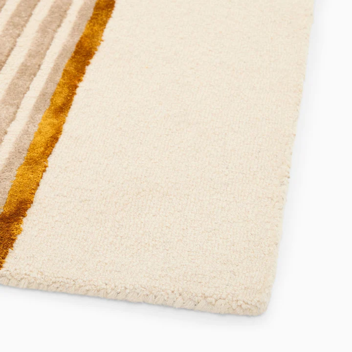 Edge detail of Aurel Gold Line Rug hand tufted wool rug highlighting clean finish and texture.