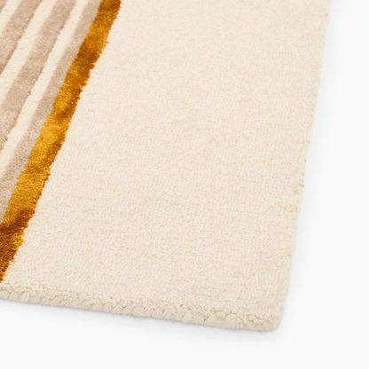 Edge detail of Aurel Gold Line Rug hand tufted wool rug highlighting clean finish and texture.