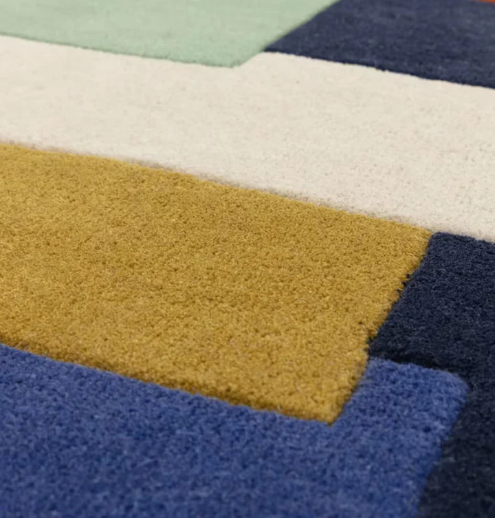 Close up detail of Axis Blocks Multicolor hand tufted wool rug showing wool texture pile height and color contrast.