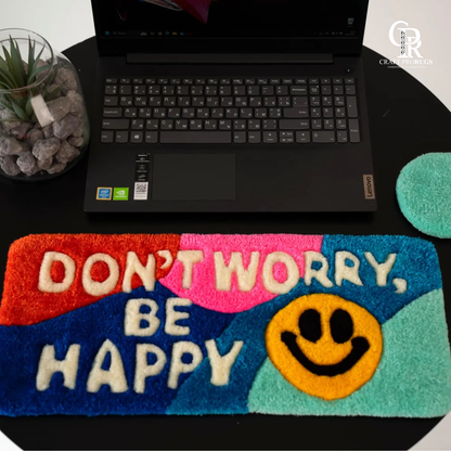 Be Happy Desk Rug front view showing don’t worry be happy text with rainbow stripes placed under keyboard for desk setup