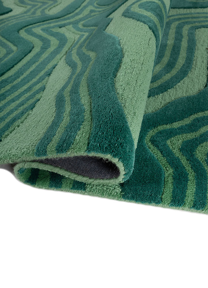 Folded corner view of Cascade Wool Rug hand tufted wool rug highlighting thickness.