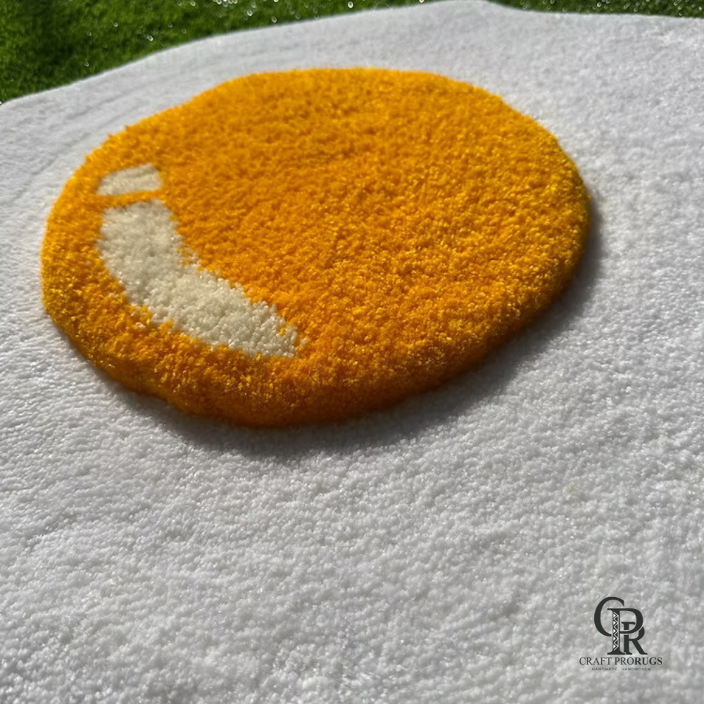 Close-up view of hand-tufted fried egg rug showing raised yellow yolk texture and soft tufted finish.