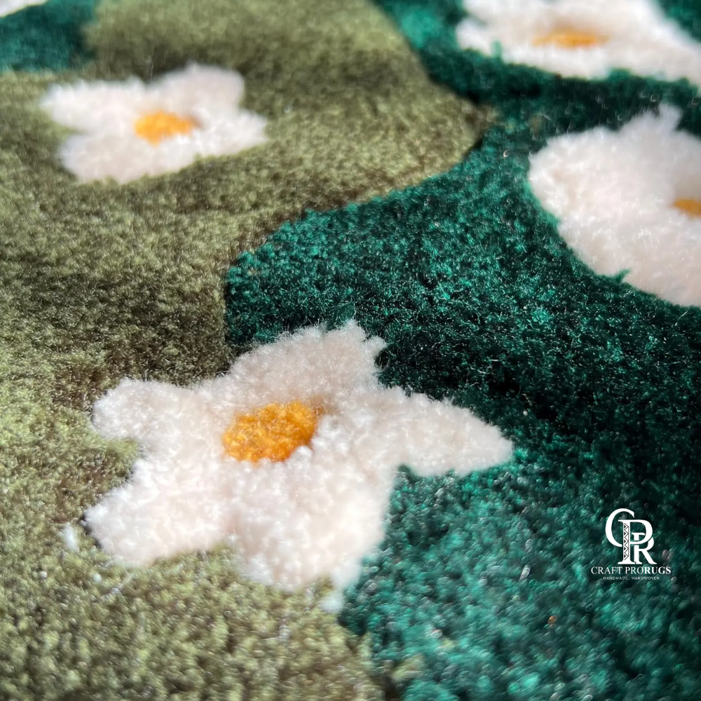 Close-up texture of hand-tufted green floral rug showing white daisy pattern and plush wool fibers.
