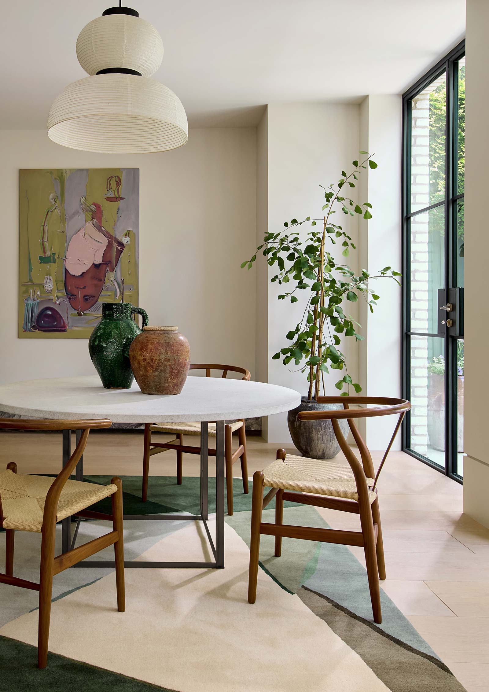 Harlequin Sumi hand tufted wool rug styled in modern living room interior with green abstract design.