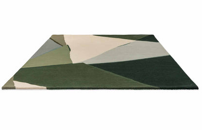 Top view of Harlequin Sumi hand tufted wool rug with modern abstract geometric shapes in green shades.