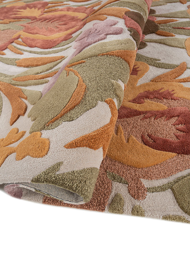 Hand tufted wool rug rolled to show plush thickness dense pile height and detailed floral pattern crafted in premium wool