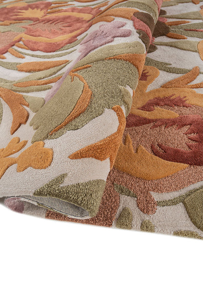 Hand tufted wool rug rolled to show plush thickness dense pile height and detailed floral pattern crafted in premium wool