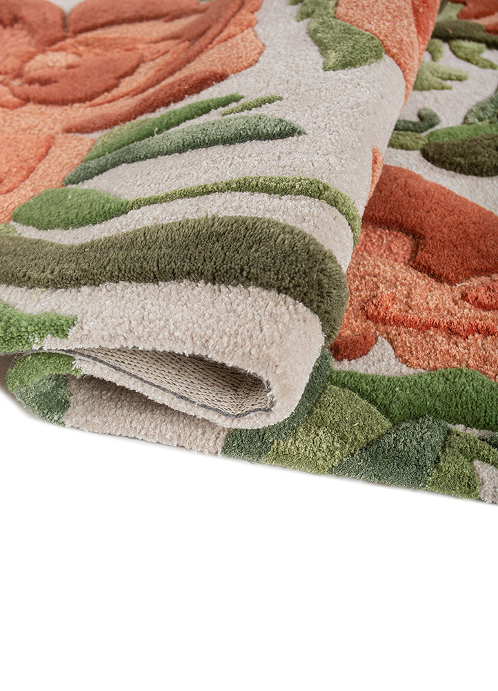 Hand tufted wool rug rolled to show plush thickness soft pile height and detailed floral pattern in premium wool.