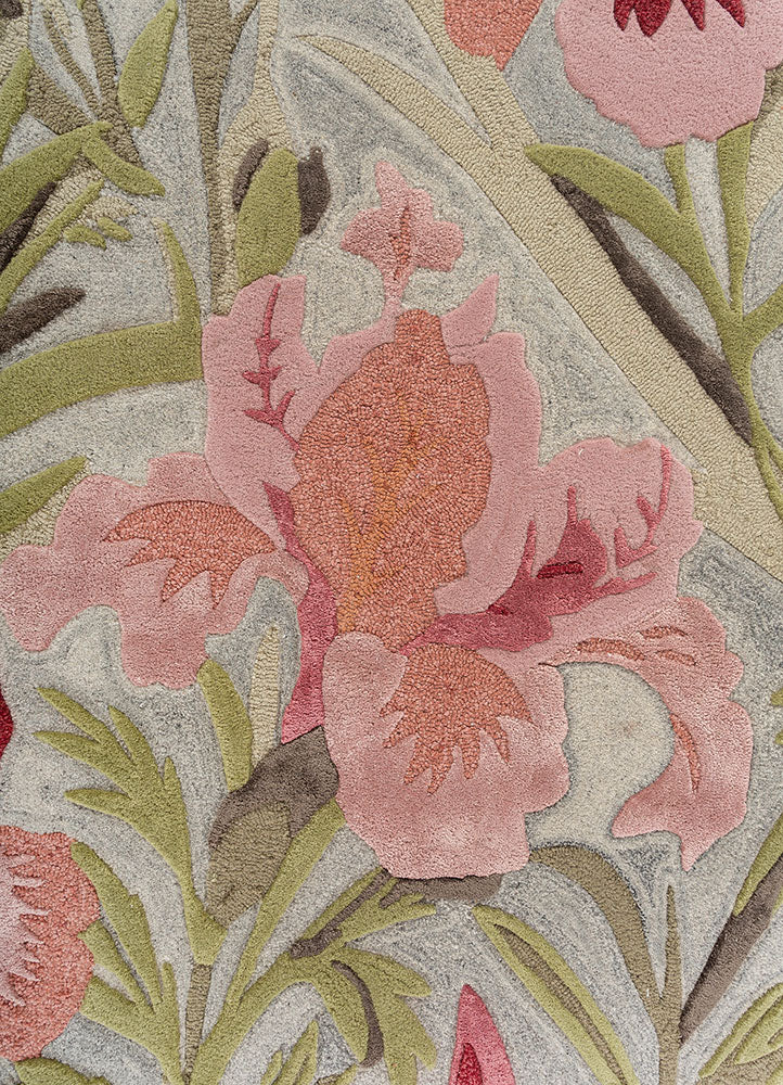 Hand tufted wool rug close view showcasing delicate floral motifs fine detailing gentle colors and soft textured wool surface.