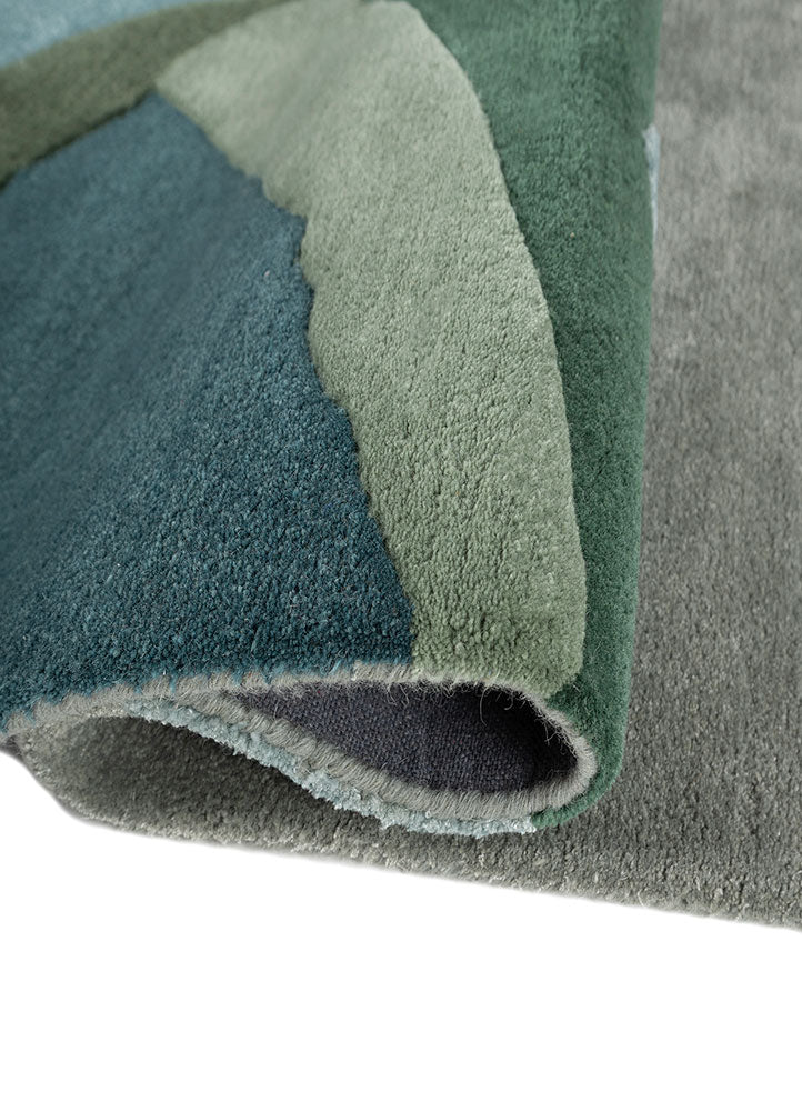Rolled edge of Verdant Ridge hand tufted wool rug highlighting thick pile premium wool texture and craftsmanship.