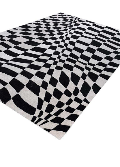 Side angle view of Abstract Optical hand tufted wool rug showing thickness and edges.