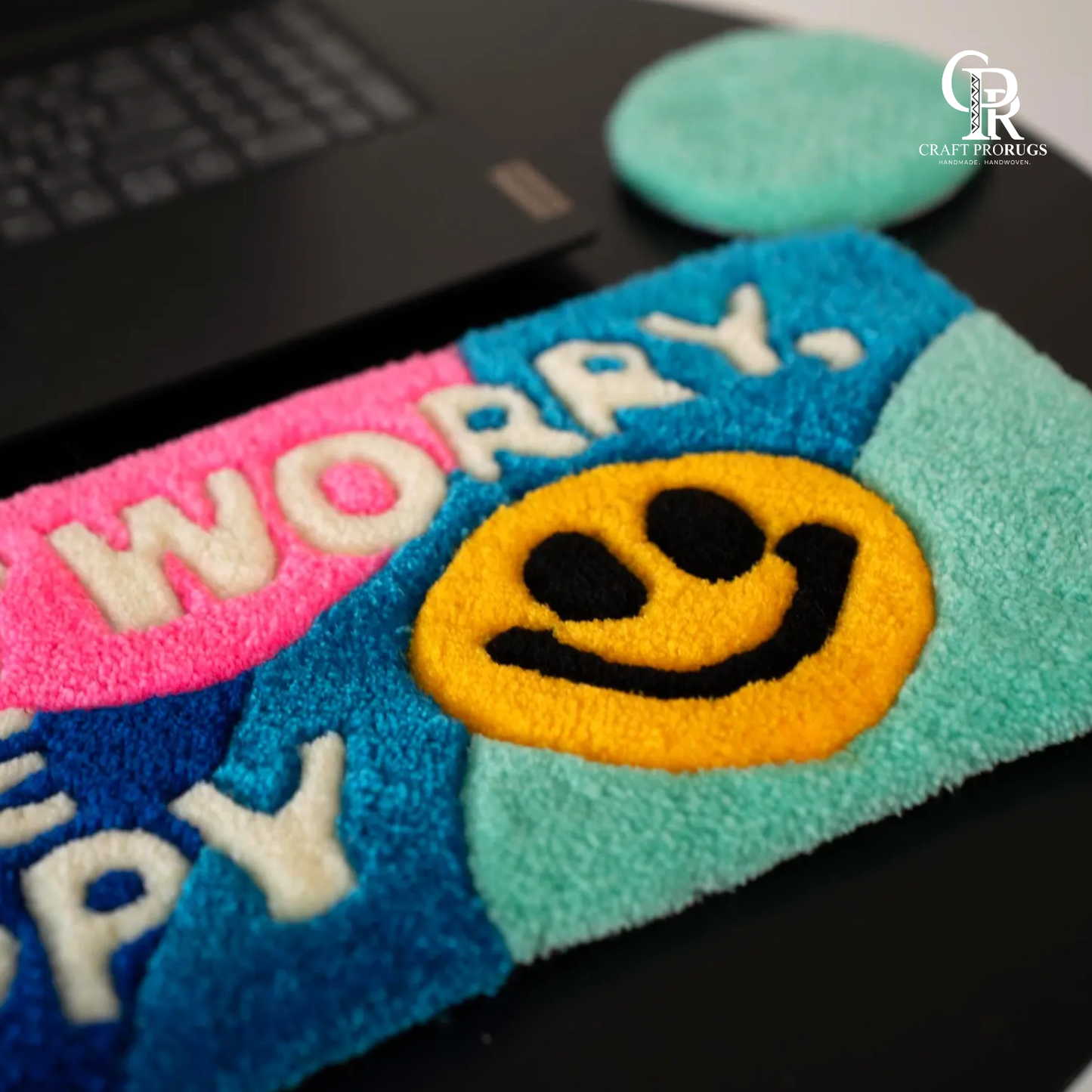 Close view of Be Happy Desk Rug highlighting soft handmade texture and detailed don’t worry be happy lettering