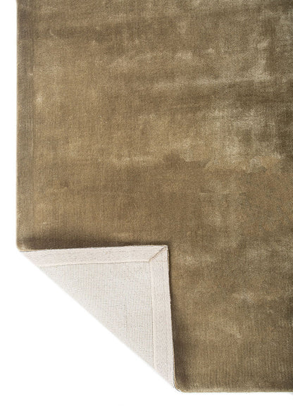 Back of hand-tufted beige wool rug, showing sturdy wool construction and soft finish.