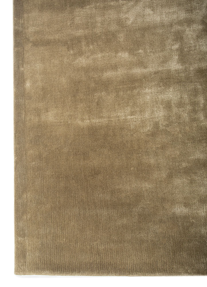 Hand-tufted beige wool rug corner view, showing smooth wool surface and fine weave.