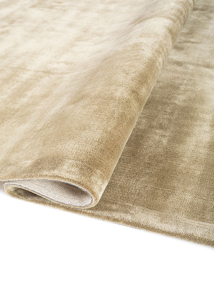 Hand-tufted beige wool rug with soft velvet-like texture, elegant minimalist wool design, full view.