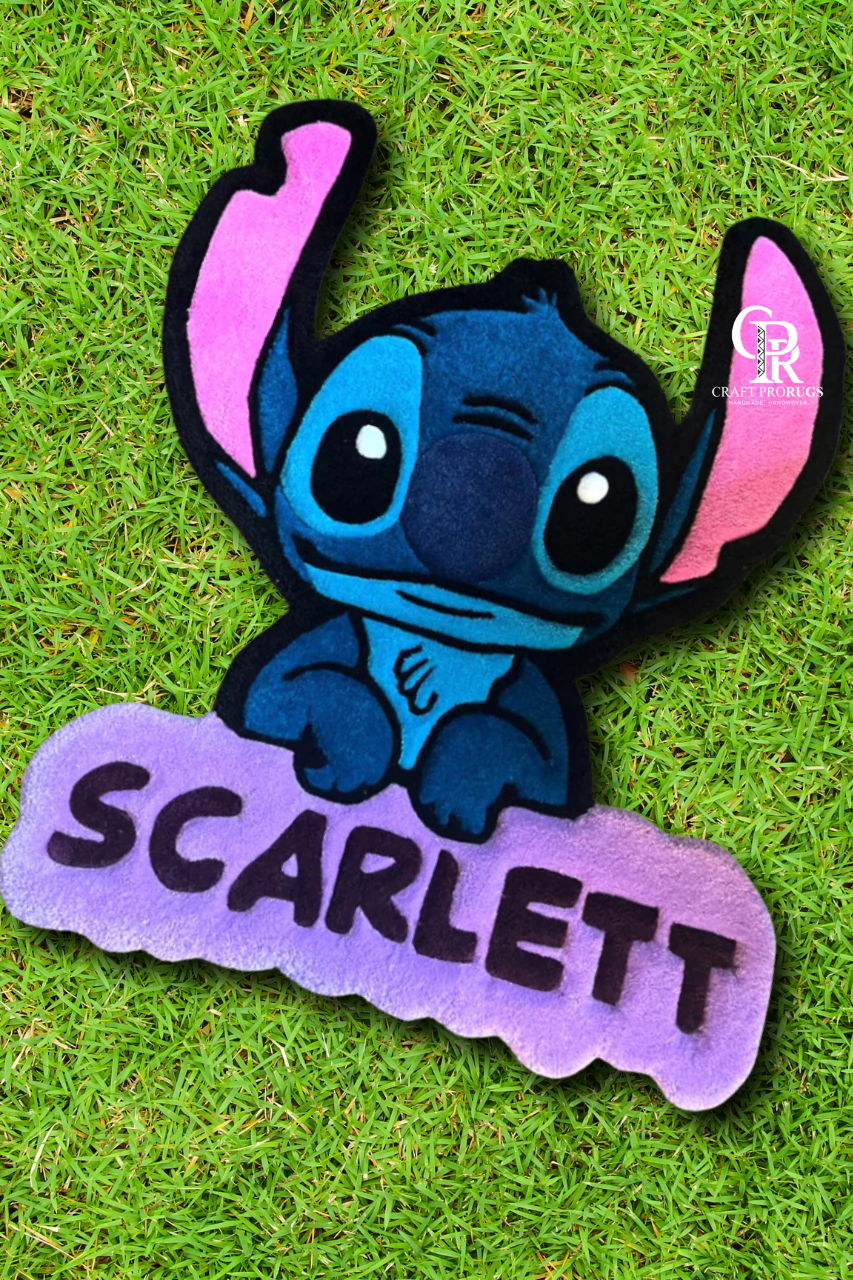 top view of blue alien hand‑tufted name rug on floor showing full design and custom name detail