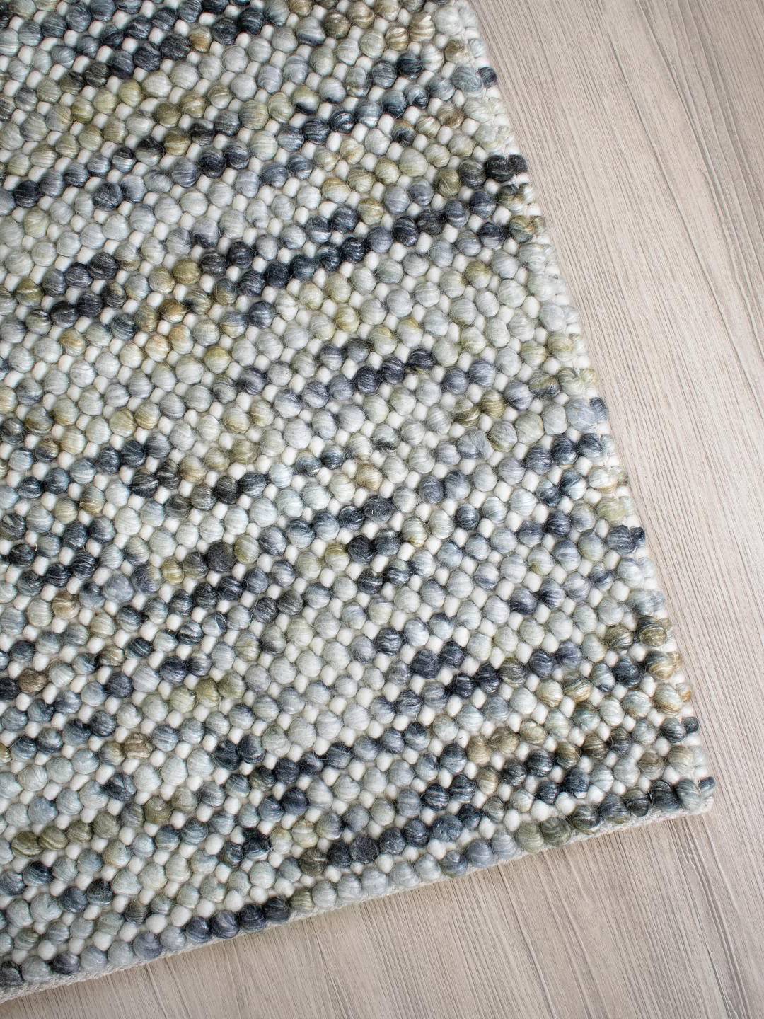 Right corner of Chalkstone Pebble flatweave rug showing detailed weave, subtle pebble pattern, and soft neutral chalk tones