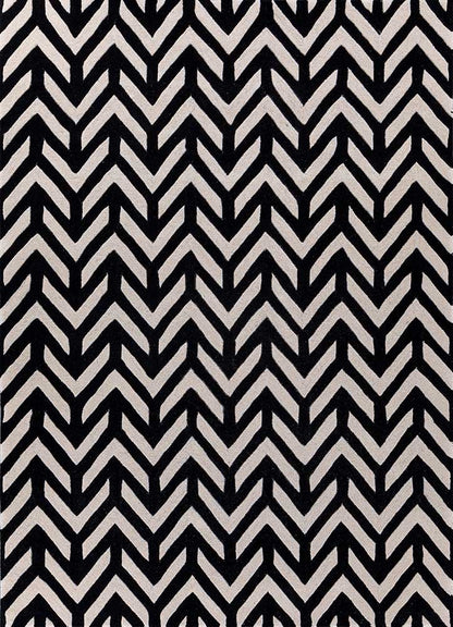 Hand tufted wool rug with black and ivory chevron pattern, modern zigzag design suitable for living room interiors.