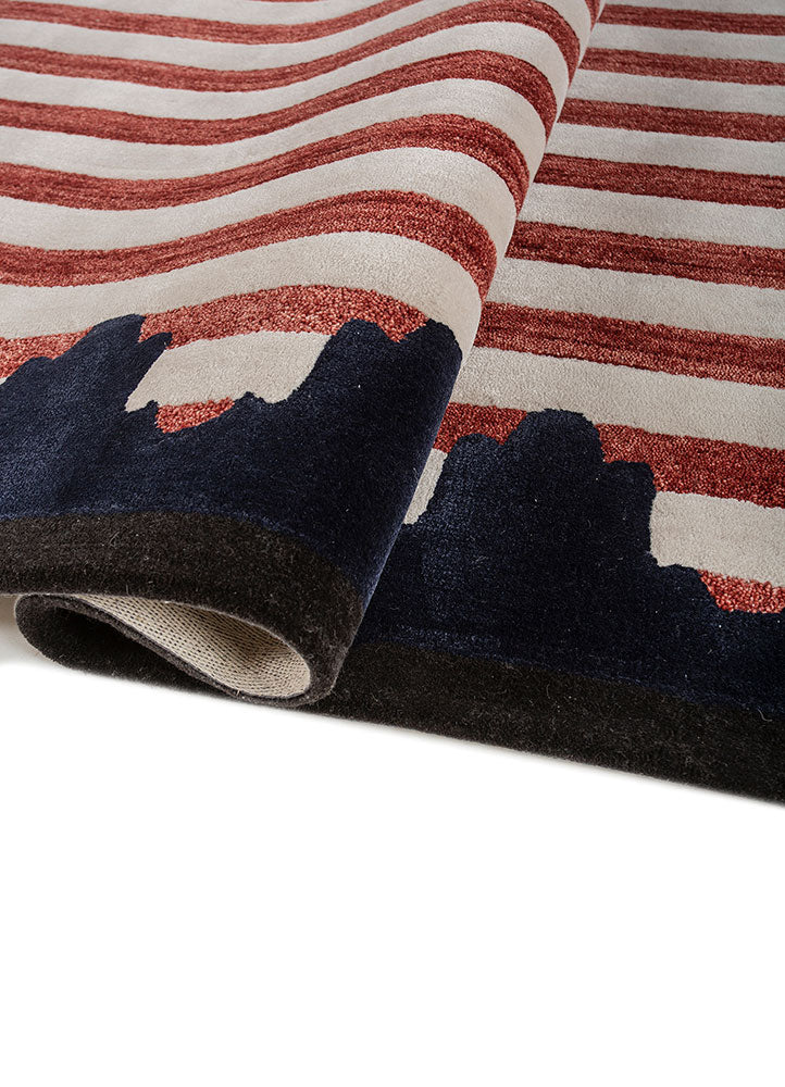 Rolled detail of Crimson Rhythm Striped hand tufted wool rug showing flexible weave plush pile and clean stripe pattern.