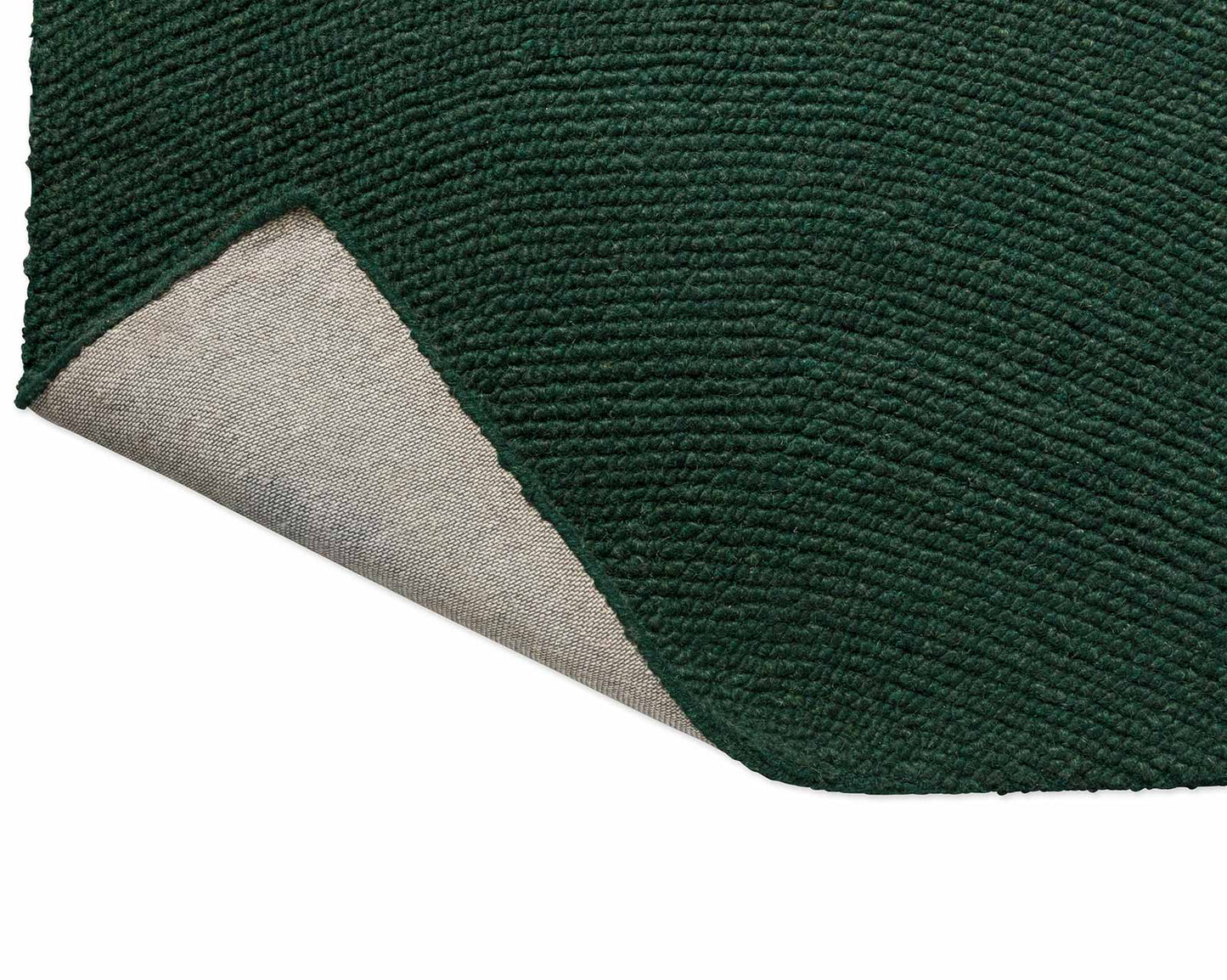 Back fold view of Echo Forest Solid hand tufted wool rug showing flexibility and durable hand tufted construction.