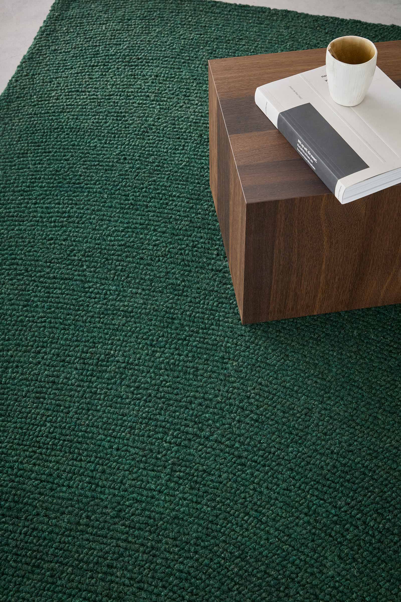 Echo Forest Solid hand tufted wool rug showing dense solid texture in deep forest green with a clean modern finish.
