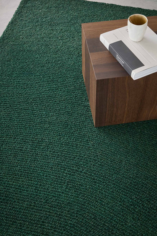Echo Forest Solid hand tufted wool rug showing dense solid texture in deep forest green with a clean modern finish.