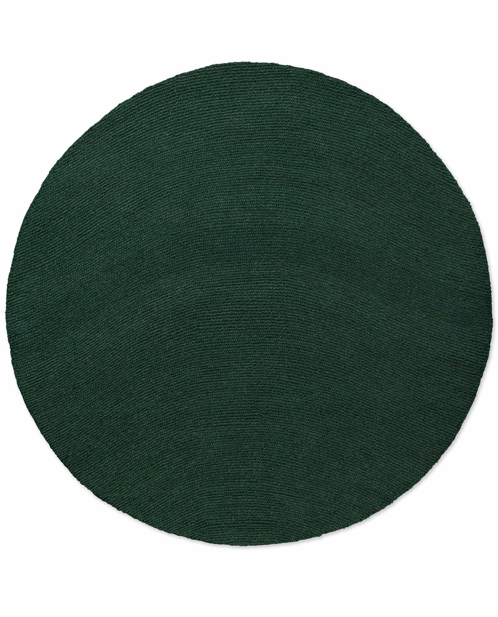 Round Echo Forest Solid hand tufted wool rug featuring smooth edges and uniform forest green wool texture.