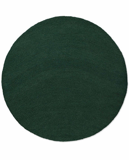 Round Echo Forest Solid hand tufted wool rug featuring smooth edges and uniform forest green wool texture.