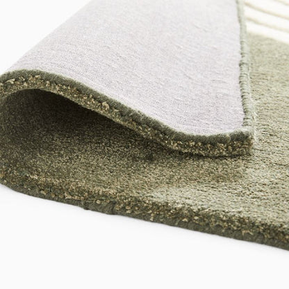 Corner fold detail of Elora Sage Oval hand tufted wool rug showing thickness texture and premium wool finish.
