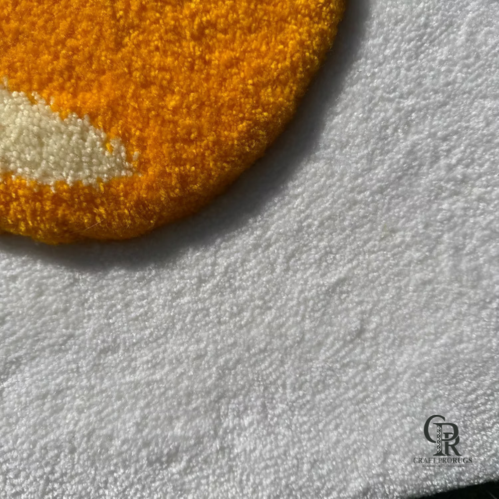 Perspective top view of fried egg hand-tufted rug showcasing soft white base and textured yolk dome.