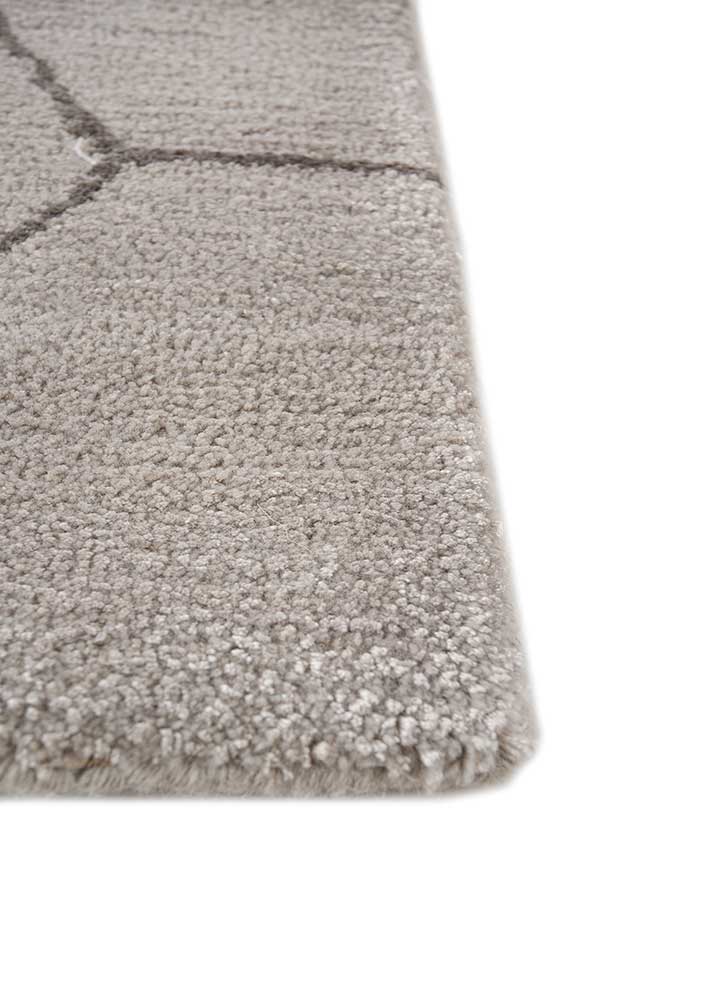 Corner close-up of Geometric Hexa hand tufted wool rug showing edge finish and pile.