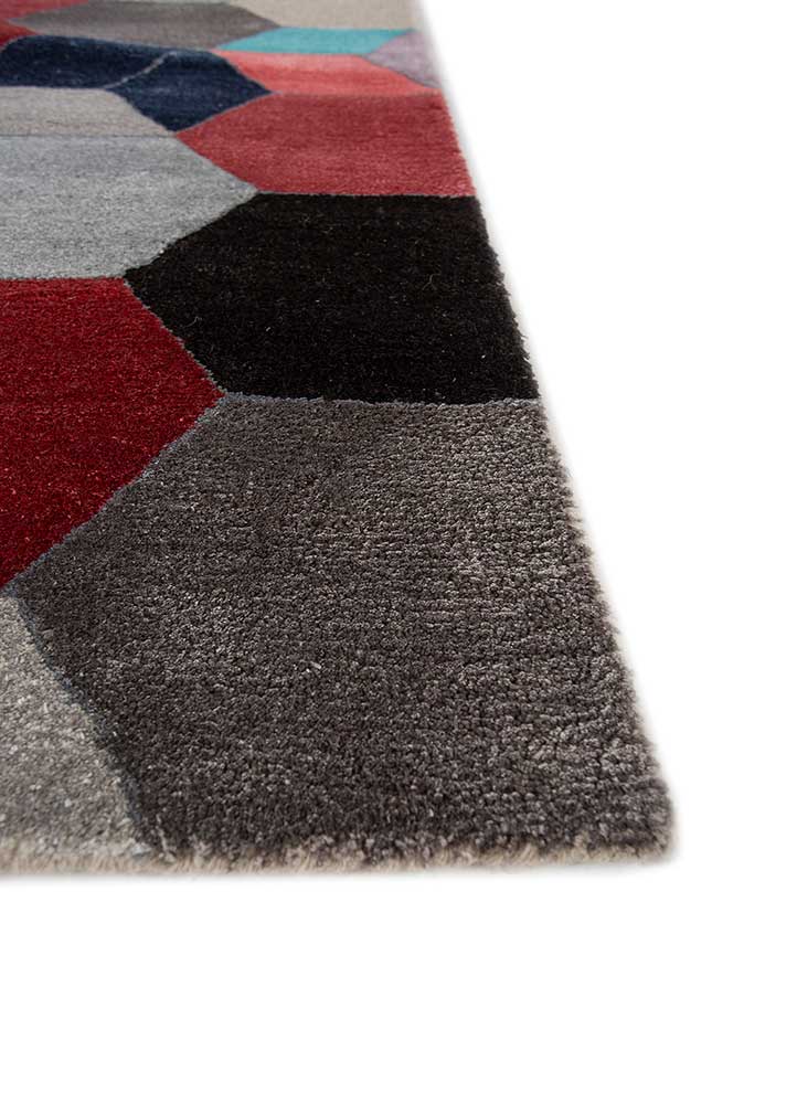 Corner close-up of Geometric Mosaic hand tufted wool rug showing edge finish.