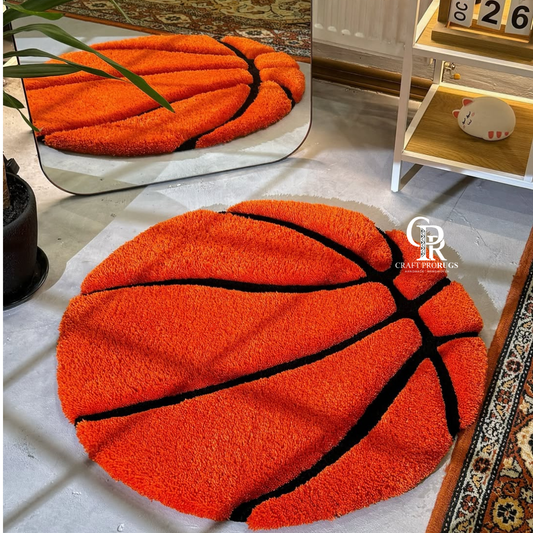 Hand-tufted basketball-shaped rug in vibrant orange and black, top view showing full design