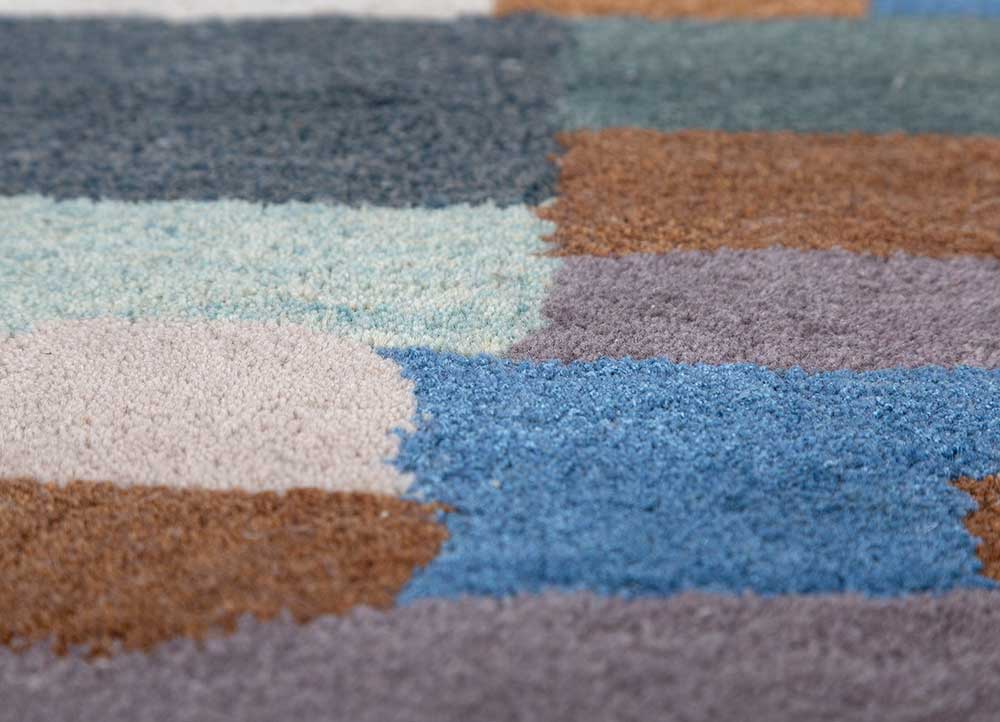 Close-up of hand-tufted Geometric Mosaic wool rug showing soft texture and vibrant multicolor geometric design.