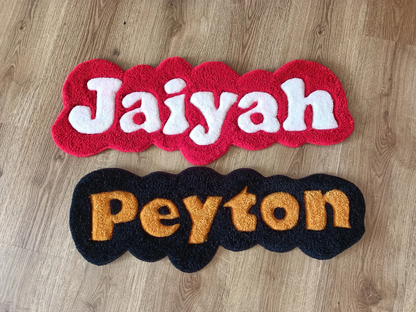 Red hand tufted rug featuring the name Jaiyah & Peyton on a wooden floor
