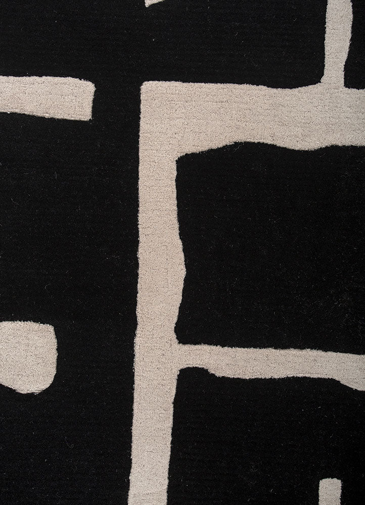 Close up texture of Linear Grid Black and Ivory hand tufted wool rug highlighting dense pile sharp lines and soft surface.