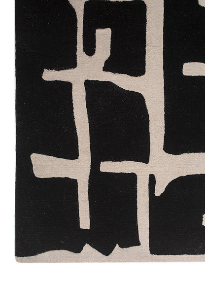 Pattern detail of Linear Grid Black and Ivory hand tufted wool rug showcasing abstract linear design with ivory accents.