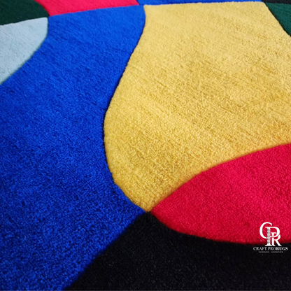 Close-up of multicolor abstract freeform hand‑tufted rug showing soft yarn texture