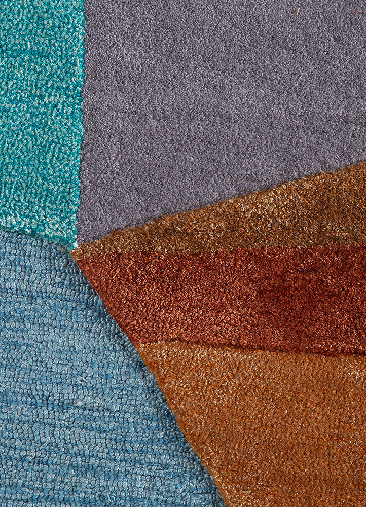 Close-up of multicolor spectrum hand-tufted wool rug showing dense wool pile, smooth texture, and premium tufting quality