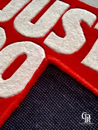 Detailed view of Nike Just Do It Red Streetwear Rug showing clean edges and dense handcrafted tufting.