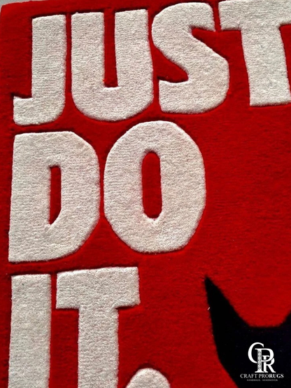 Close-up of Nike Just Do It Red Streetwear Rug highlighting raised lettering and premium hand-tufted wool texture.