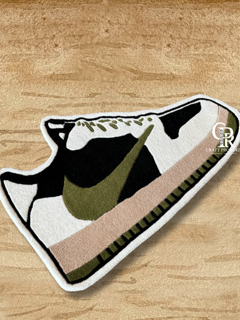 Top view of Nike shoe shape rug handcrafted with dense hand-tufted pile in brown olive tones