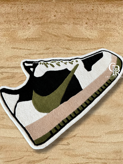 Top view of Nike shoe shape rug handcrafted with dense hand-tufted pile in brown olive tones