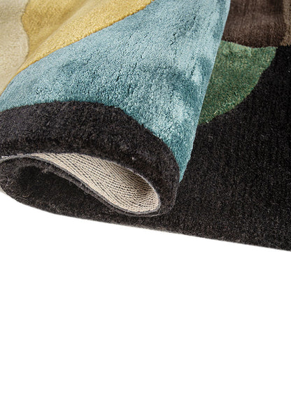 Rolled corner view of Obsidian modern abstract wool rug showing thickness and texture.
