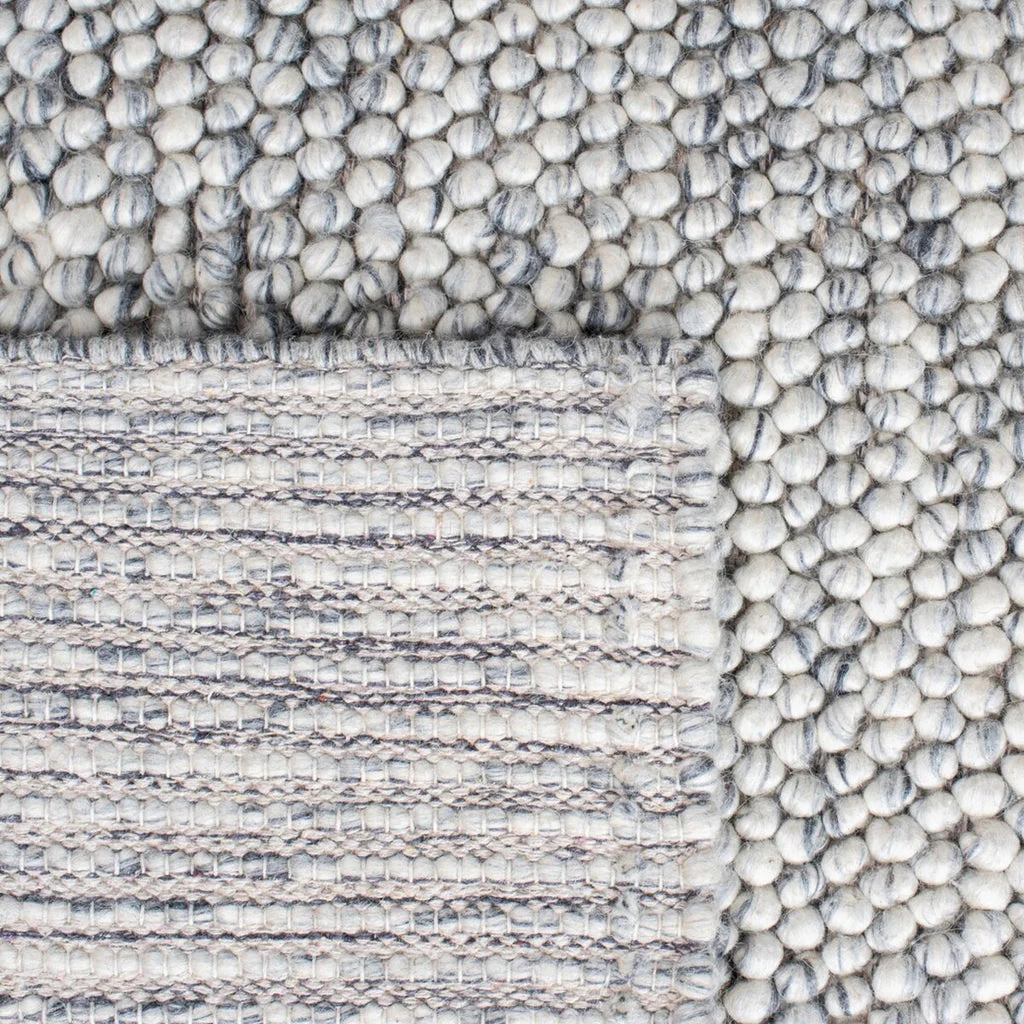 Backside of pebble texture flatweave pure wool rug showing handwoven construction
